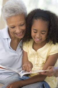 Grandmother showing grandaughter the Patient Better workbook and how families work together to take care of their health as a family.