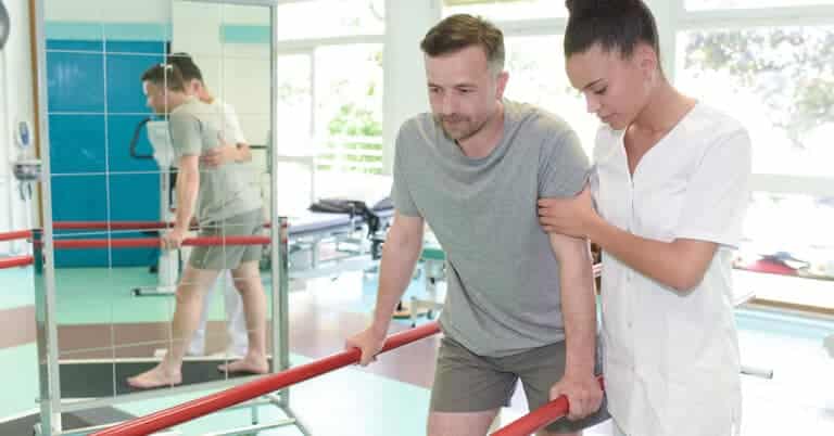 Patient engaging in physical therapy as part of an ancillary care network for comprehensive healthcare.