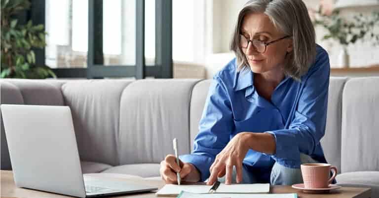 Senior woman at home managing her medical record for optimal healthcare outcomes.