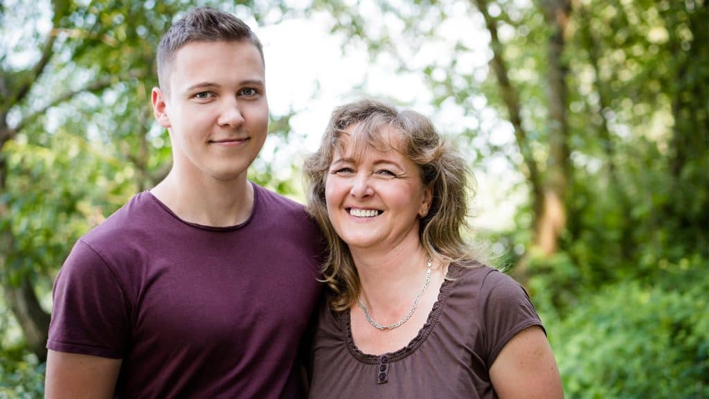 Portrait of mom with son who she is caring for and organizing his medical record management.