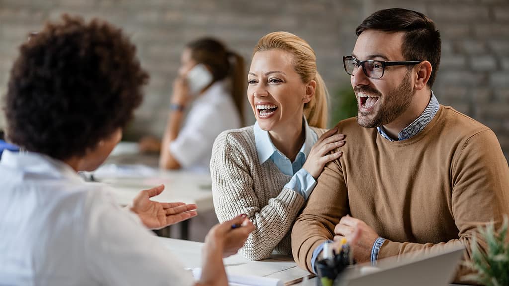 A cheerful meeting between a healthcare professional and two engaged individuals, exemplifying the interaction with 'healthcare educators.