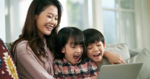 A smiling woman with two children, conveying the joy and importance of patient autonomy in family health decisions.