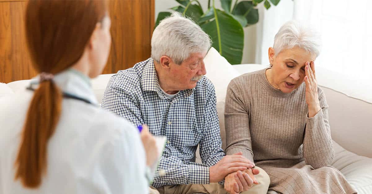 An elderly couple in a medical office with a healthcare professional, showcasing the concept of 'Trust in Healthcare'.