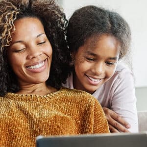 A mother and child smiling together, possibly reflecting on the importance of managing Medical Expenses.