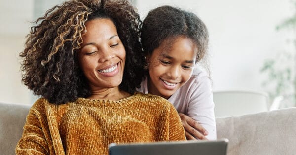 A mother and child smiling together, possibly reflecting on the importance of managing Medical Expenses.