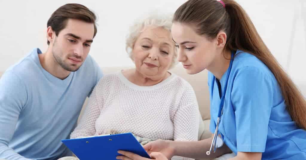 A healthcare professional discussing treatment options with an elderly patient and a family member, illustrating a collaborative approach to healthcare decisions.