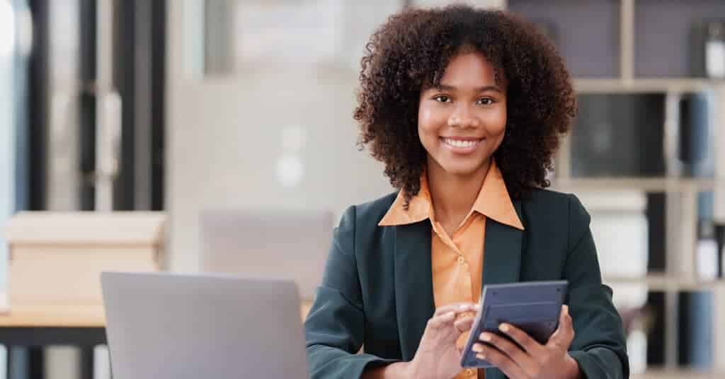 A confident young woman with a digital tablet, likely researching or accessing wellness resources online.