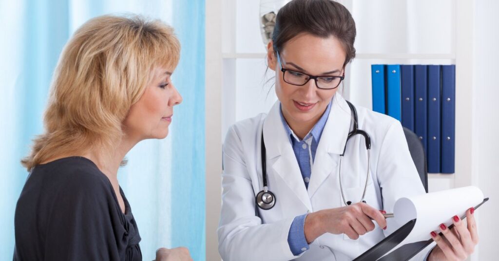 A clinician discusses a treatment plan with a patient, highlighting personalized care. The doctor, dressed in a white coat and wearing glasses, points to specific details on a document, illustrating the tailored approach to managing the patient’s health condition. The patient, attentively listening, reflects the collaborative nature of developing an effective treatment plan. This interaction emphasizes clear communication and shared decision-making in healthcare.