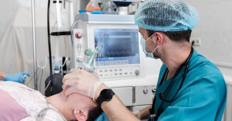 An anesthesiologist monitoring a patient under anesthesia during surgery, illustrating what is anesthesiology and the importance of patient safety and pain control.