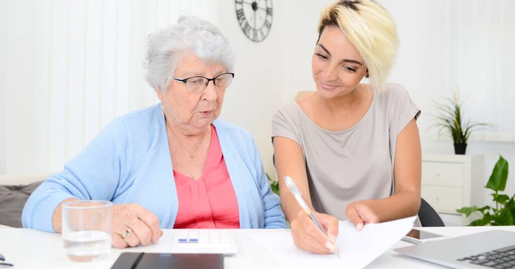 A patient navigator providing one-on-one guidance to help patients understand care plans, organize documents, and navigate the healthcare system.