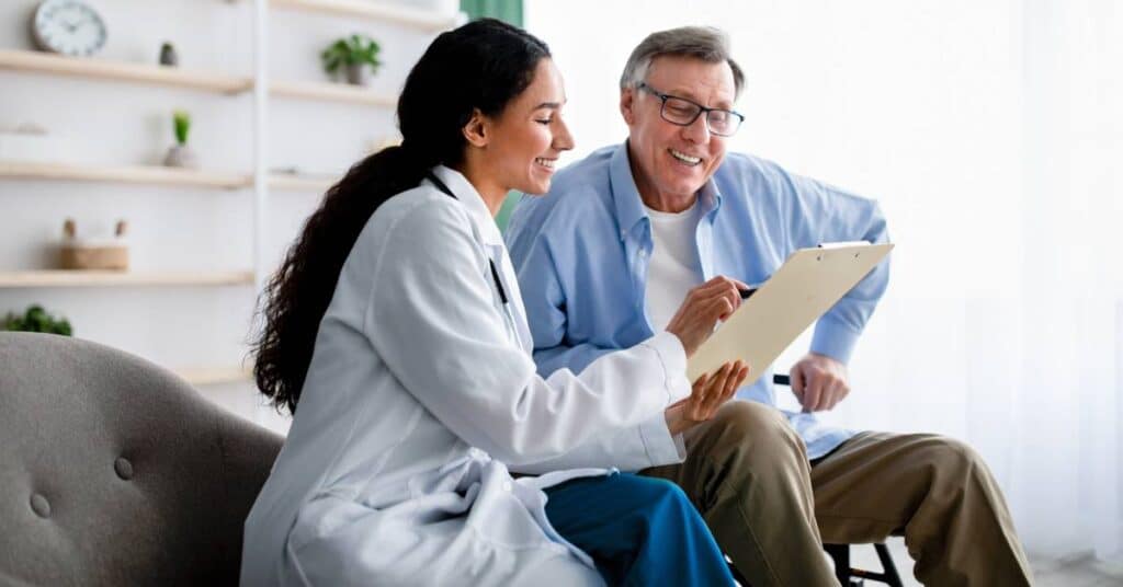 A healthcare professional reviewing a patient’s care plan during a chronic disease management appointment, focusing on long-term treatment and support.