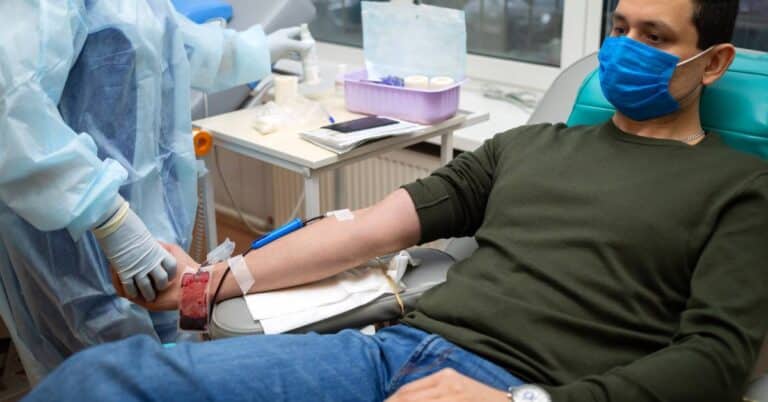 A patient receiving a blood test under medical supervision, illustrating how hematology focuses on diagnosing and treating blood-related conditions with expert care.