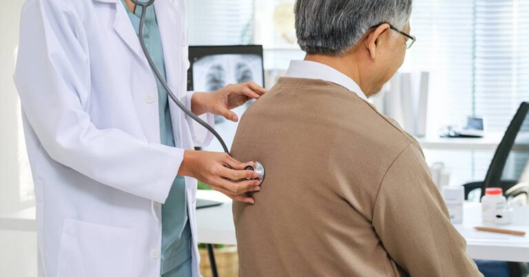A pulmonologist using a stethoscope to examine a patient’s breathing in a medical office, representing pulmonology and respiratory health care.