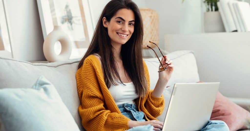 A woman researching at home on her laptop, illustrating how to navigate your healthcare journey with confidence.