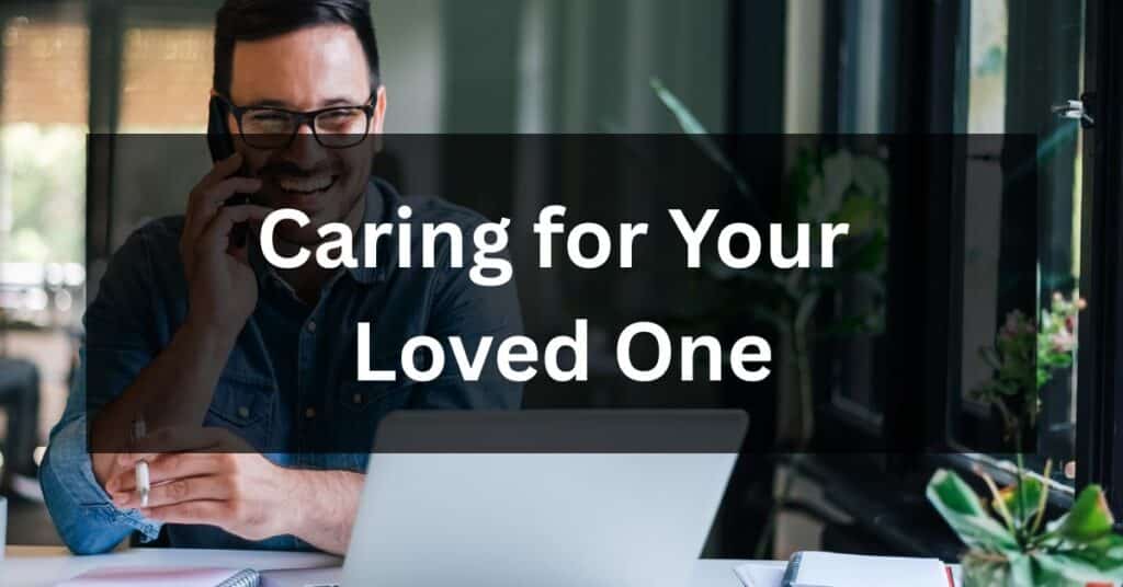 Man talking on the phone while looking at a laptop, illustrating the challenges of caring for your loved one at home or at a distance.