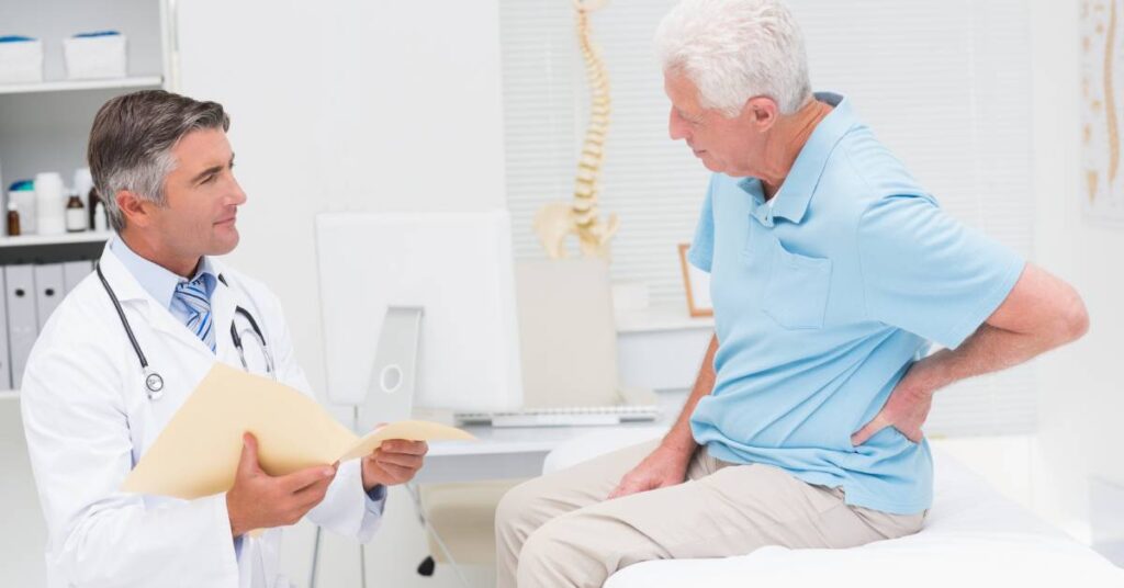 Doctor reviewing lumbar disc herniation symptoms with patient during post-op recovery visit.