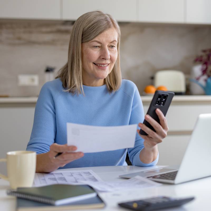 Patient organizing medical paperwork and care instructions at home as part of patient navigation education.