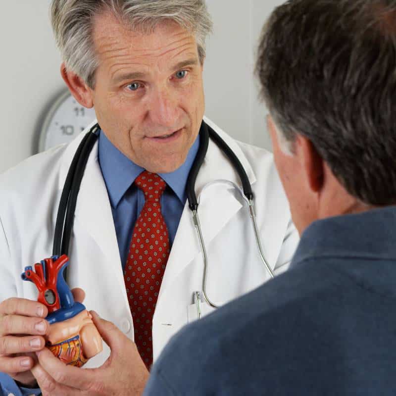 Specialist explaining a treatment plan to a patient to improve understanding, adherence, and follow-through.